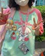 Close-up of a person wearing a lolita aesthetic tee with cute character illustrations.