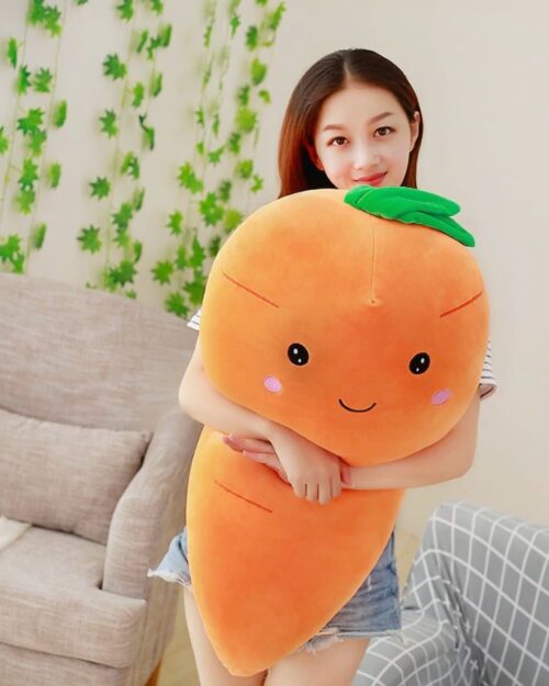 A kawaii carrot plushie being held by a person.