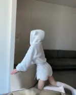 A person wearing white bear pajamas, a kawaii clothes set.