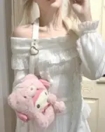 White himekaji aesthetic sweater with lace detailing and off-shoulder design, held by a plush toy.