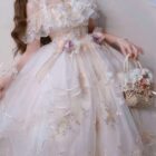 A pink floral lolita dress with ruffles and lace details, featuring a basket and accessories.