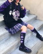 Black Kawaii Cartoon Hoodie with purple accents, worn by a person.