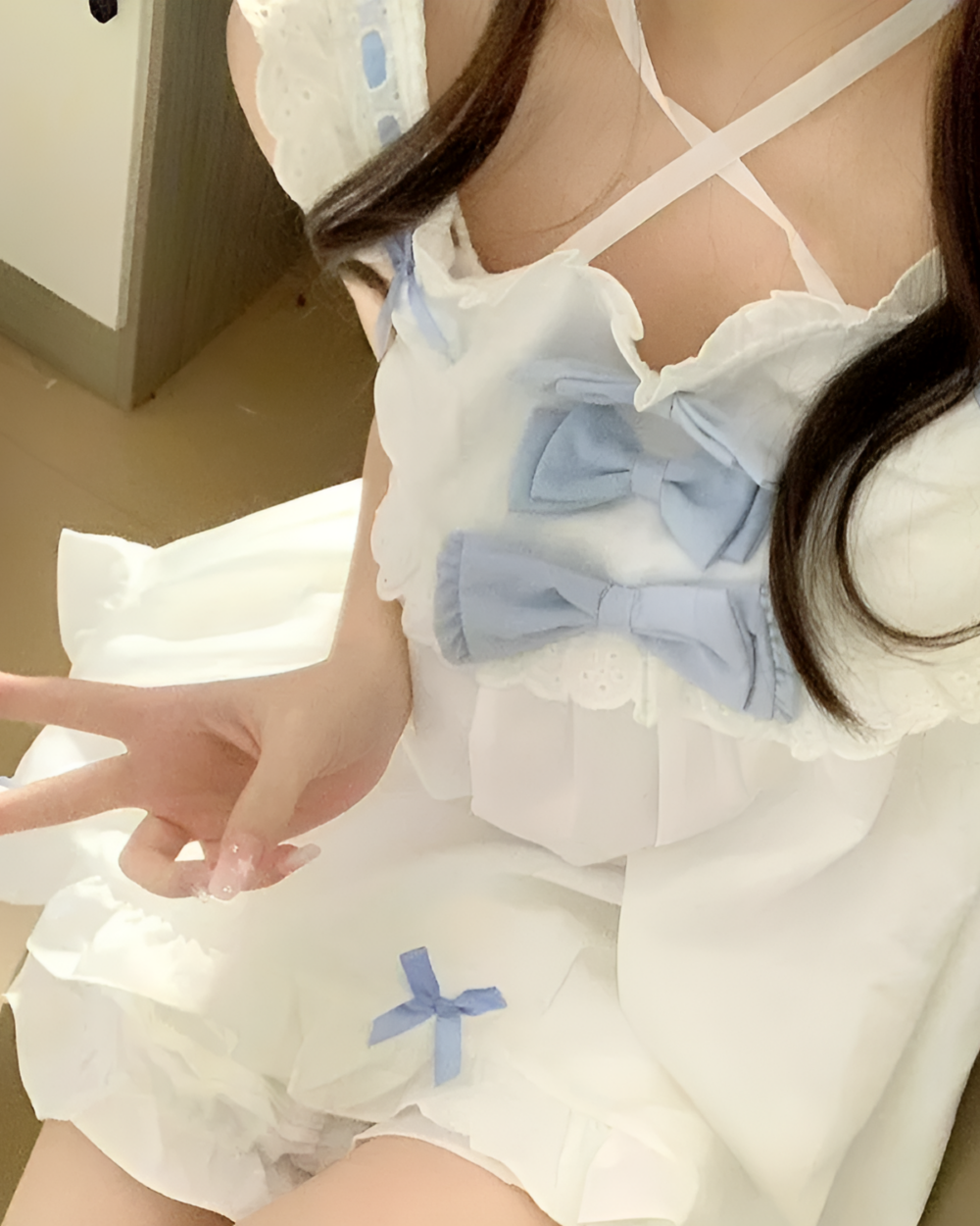 Close-up of a Cloudy Bowed Two Piece Yume Kawaii Set featuring a white top and matching skirt with blue bows.