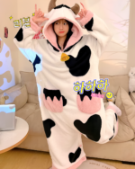 A white Cow Onesie with black spots, featuring a hood and ears. Kawaii pajamas.