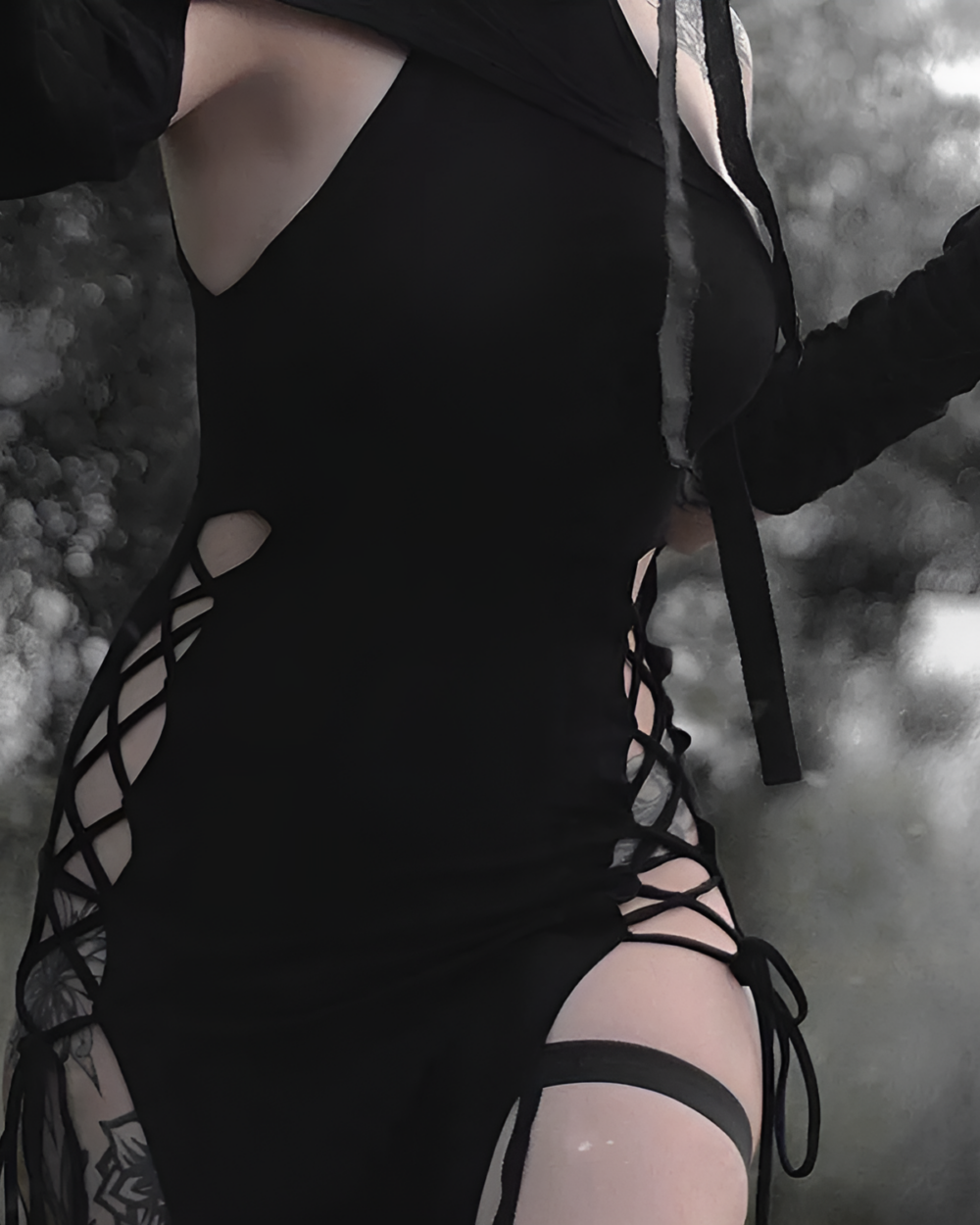 Close-up of a black Nu-Goth Aesthetic Dress with cutouts and lacing details.