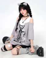 Gray Grunge Aesthetic Top with graphic print, layered with a white shirt and worn casually.