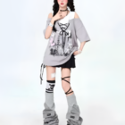 Model wearing a Grunge Aesthetic Top with a graphic print, layered with a loose t-shirt and paired with leggings and boots.