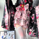 Floral Short Yukata featuring a pink and black floral print, worn with matching accessories.