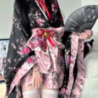 Floral Short Yukata featuring a pink and black floral print, with a wide belt and stockings.