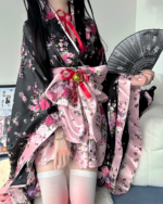 Floral Short Yukata featuring a pink and black floral print, with a wide belt and stockings.