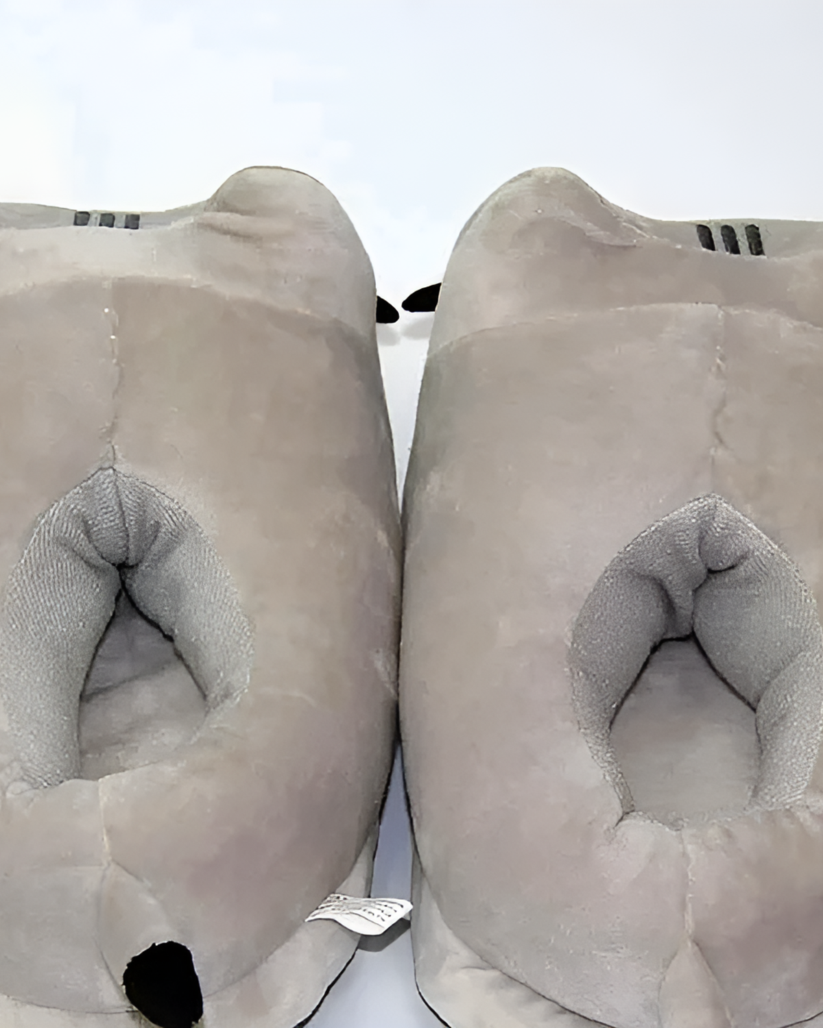 Close-up of gray Fluffly Pusheen slippers with plush lining.