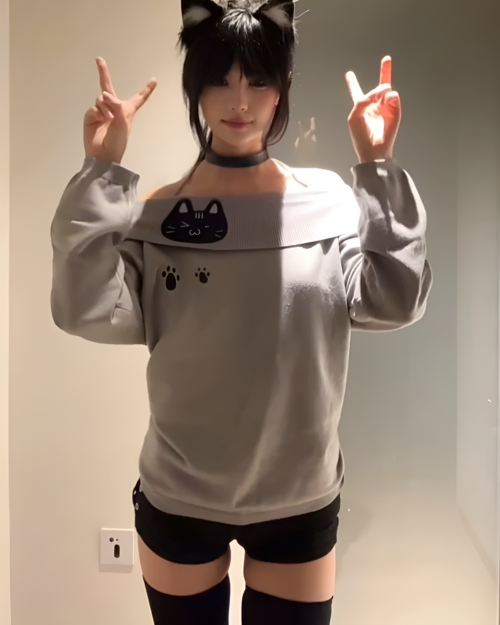 Gray Grak Cat Off-Shoulder T-Shirt with cat paw prints, worn by a person.