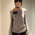 Grey Grak Cat Off-Shoulder T-Shirt with cat paw print design.