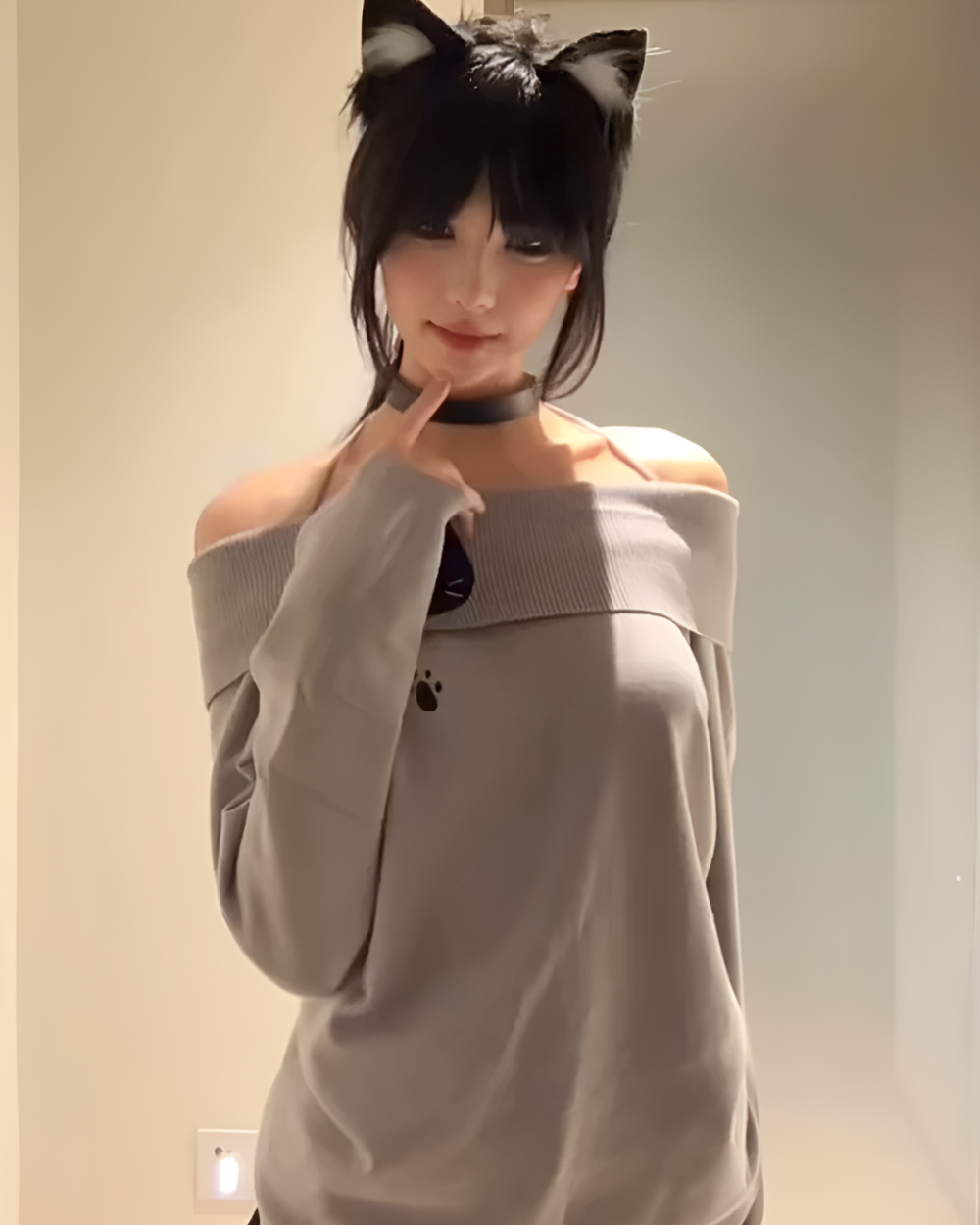 Gray Grak Cat Off-Shoulder T-Shirt with paw print detail, worn by a person.