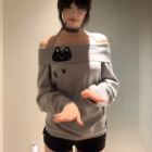 Model wearing a Grak Cat Off-Shoulder T-Shirt featuring cat paw prints and ears.