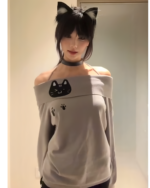 Model wearing a Grak Cat Off-Shoulder T-Shirt with cat ears and paw prints.