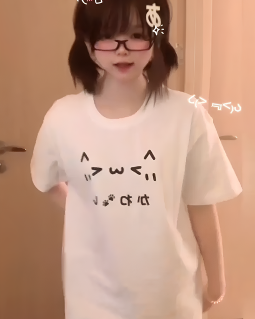 White Kaomoji Cat T-Shirt worn by a person. Kawaii clothing design.