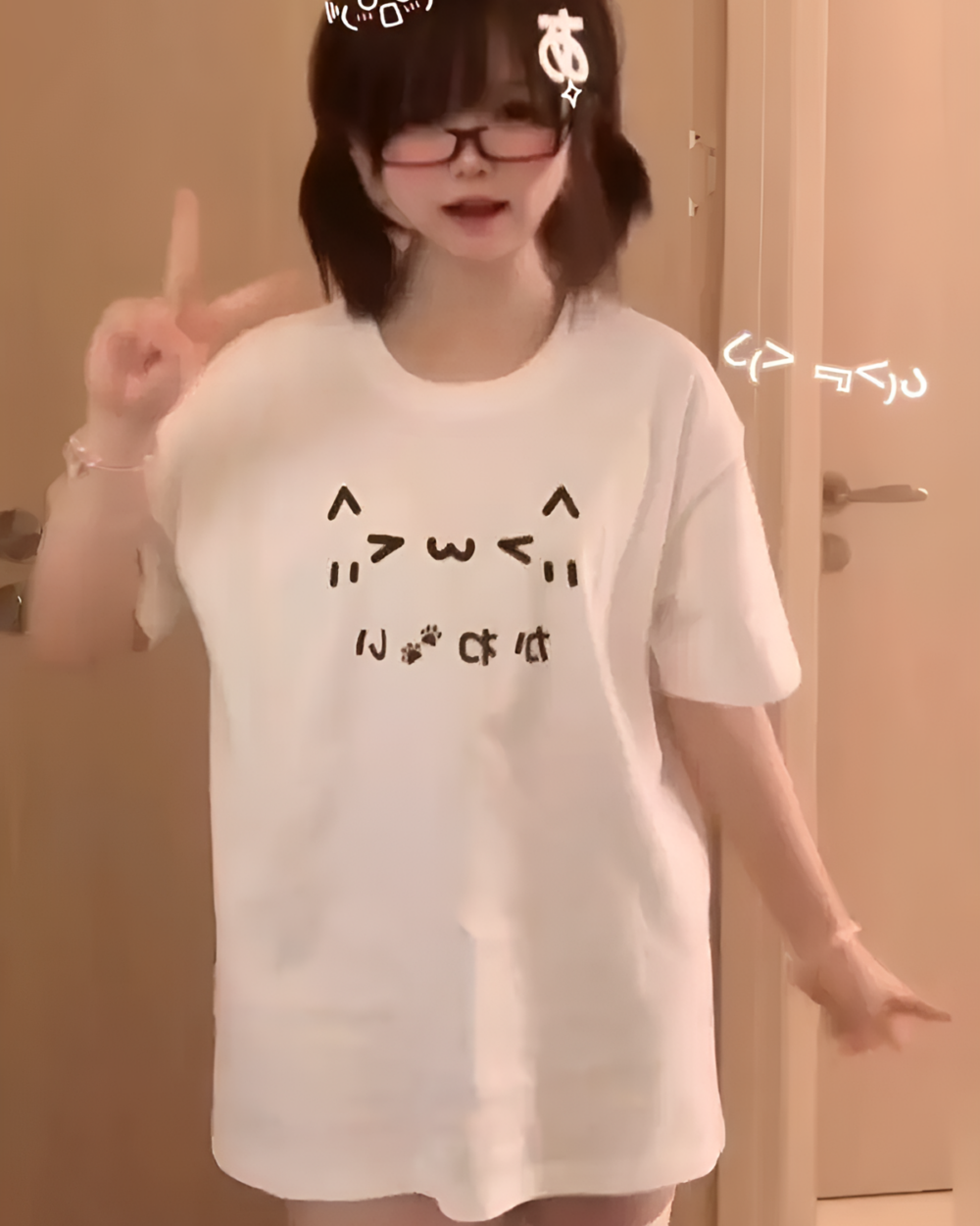 Woman wearing a Kaomoji Cat T-Shirt featuring a cat face design.