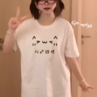 Woman wearing a Kaomoji Cat T-Shirt featuring a cat face design.