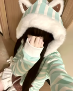 Person wearing a Mint Furry Hoodie with a white faux fur hood and striped design.