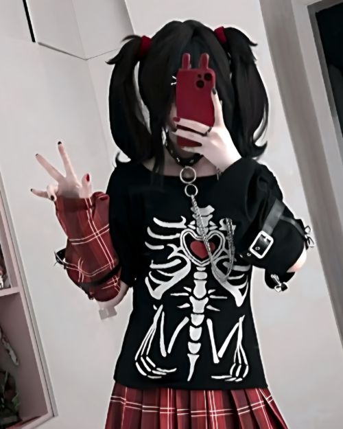 Person wearing a Needy Girl Overdose T-Shirt featuring a skeleton print and layered accessories.