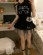 Black Cutecore Aesthetic Top with kawaii cat design, layered with a skirt.