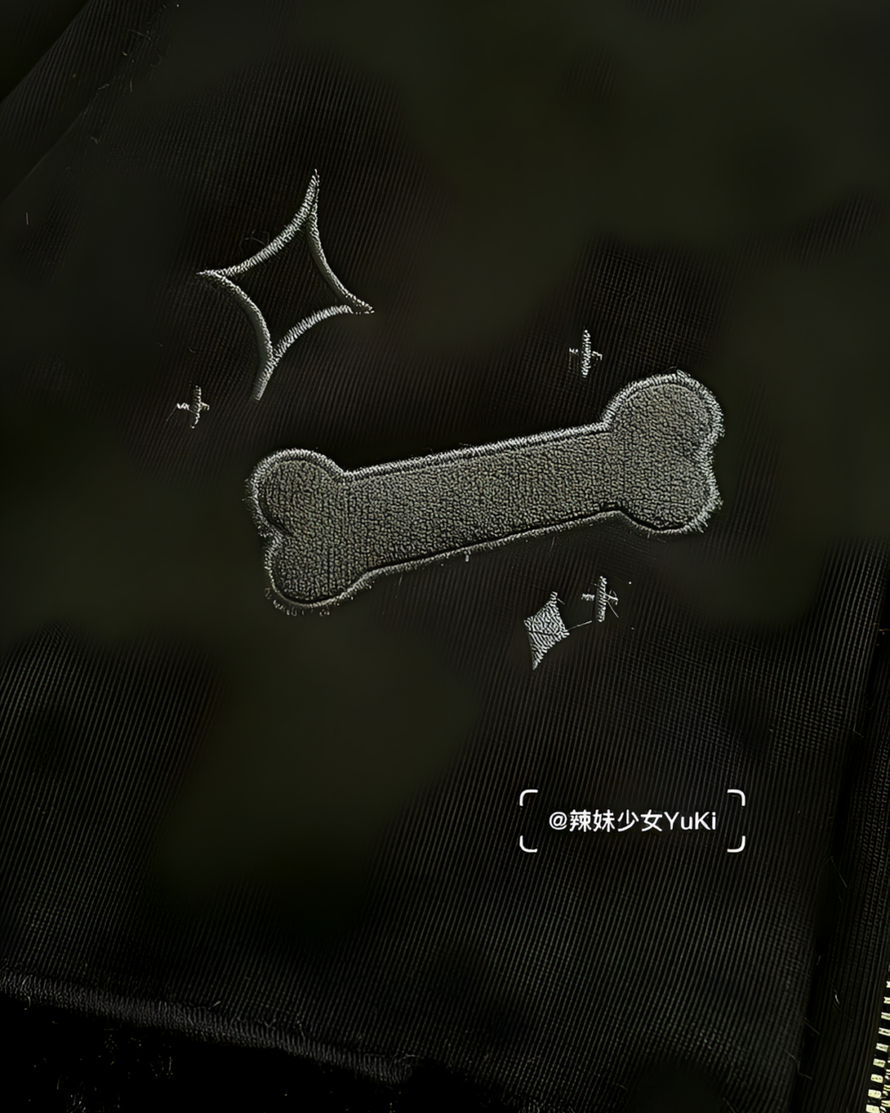 Neko Paw Hoodie featuring an embroidered bone graphic and signature tag.