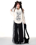 Model wearing a Grunge Butterfly Top, off-shoulder design, with lace trim and black accessories.