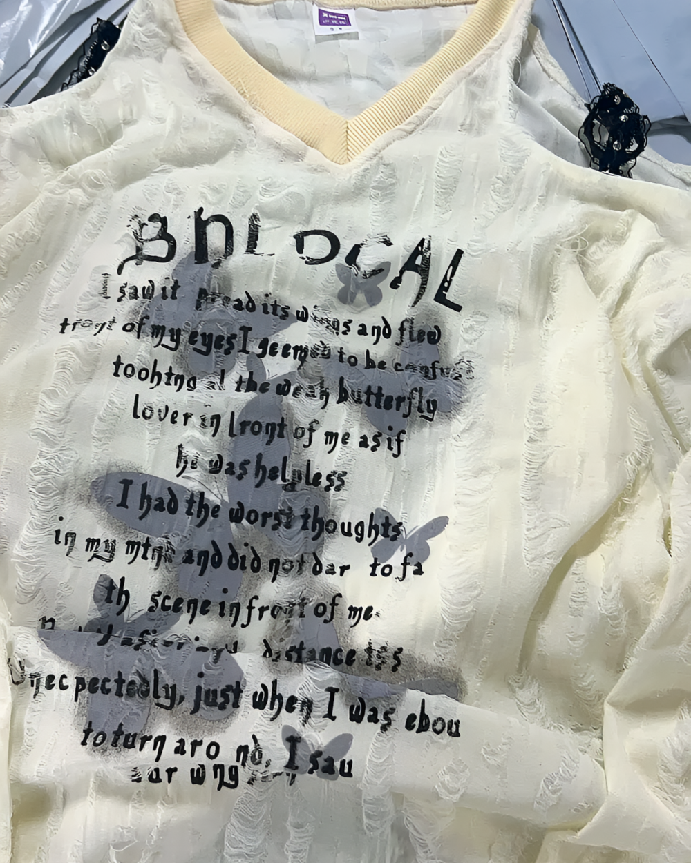 Off-Shoulder Grunge Butterfly Top, featuring a distressed, floral print and lace details.