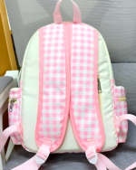 White Plaid Strawberry Backpack featuring a pink gingham design and adjustable shoulder straps. Product-keyword: Plaid Strawberry Backpack