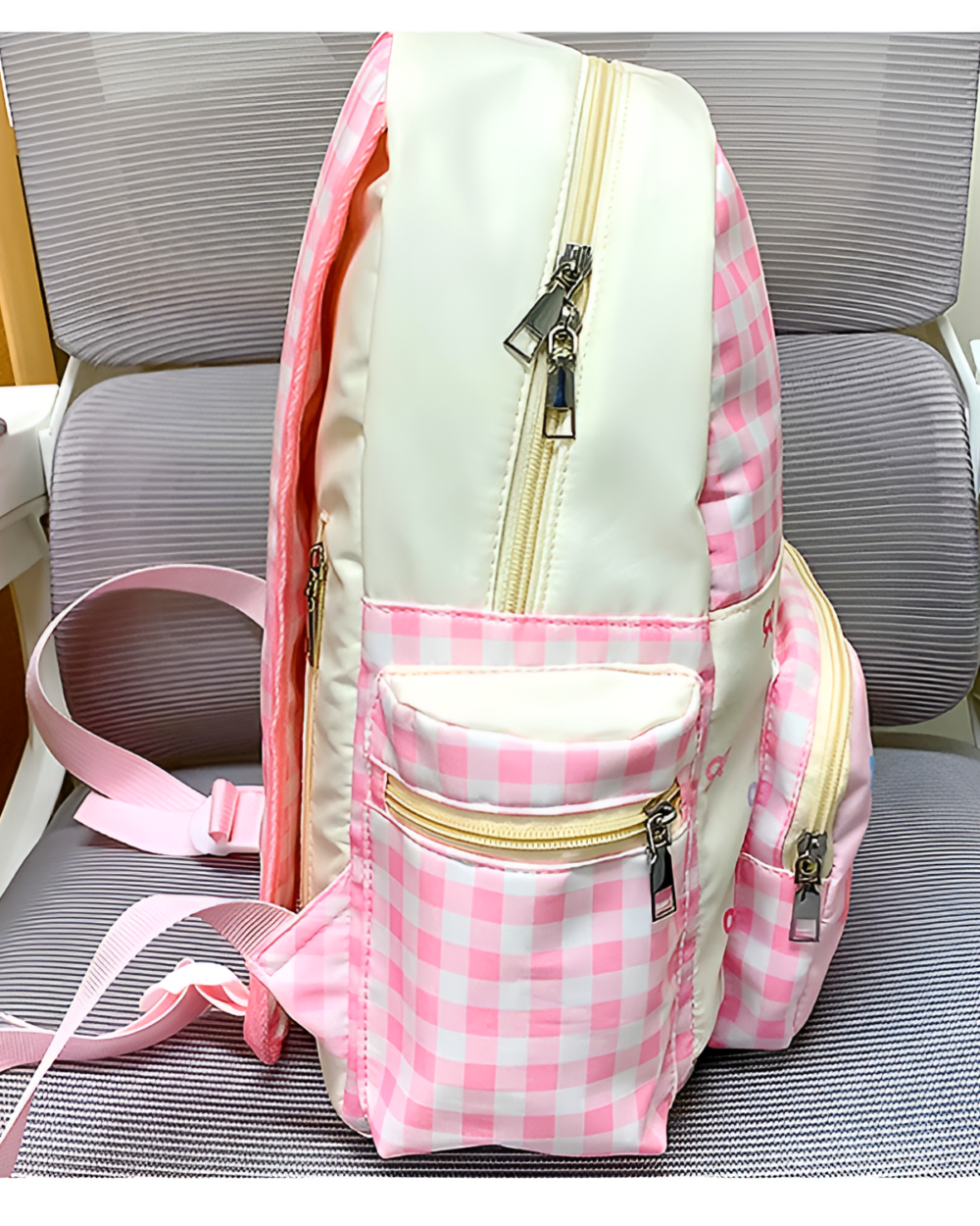 Plaid Strawberry Backpack showcasing pink and white gingham details with zipper closures.