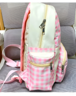 Plaid Strawberry Backpack showcasing pink and white gingham details with zipper closures.