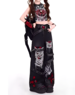 Black Y2K aesthetic pants featuring ripped detailing and a distressed style.