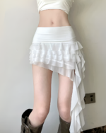 White Ruffles Low-waisted Coquette Aesthetic Skirt, featuring layered ruffles and a high-low design.