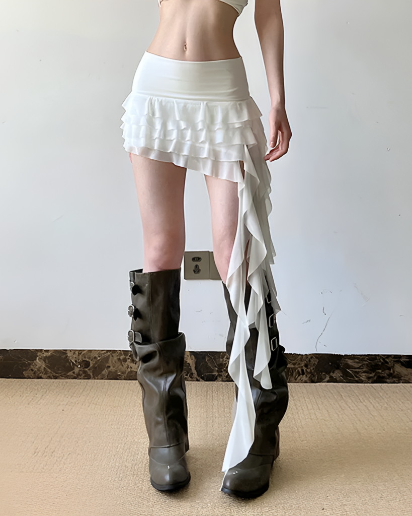 White ruffled Coquette Aesthetic Skirt with asymmetrical hemline, low-waisted style.