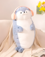 Cute Kawaii Seal Plushie resting on a sofa with a newspaper.