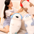 Cute Kawaii Seal Plushie with headphones, sitting on a chair with another plushie.