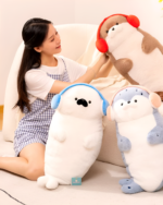 Cute Kawaii Seal Plushie with headphones, sitting on a chair with another plushie.