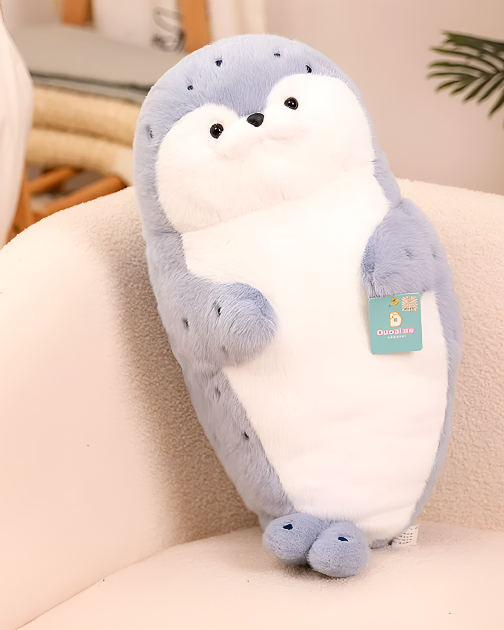 Kawaii Seal Plushie, a soft, blue, long-armed plush toy with black eyes and paws.