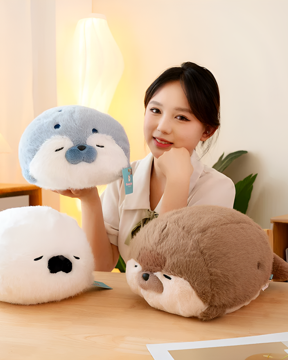 Kawaii Seal Plushie and Otter Plushies displayed with a person.