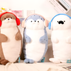 Two Kawaii Seal Plushies, one light blue and one brown, with headphones.