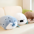 Two Kawaii Seal Plushies, one blue and one white, resting on a sofa.