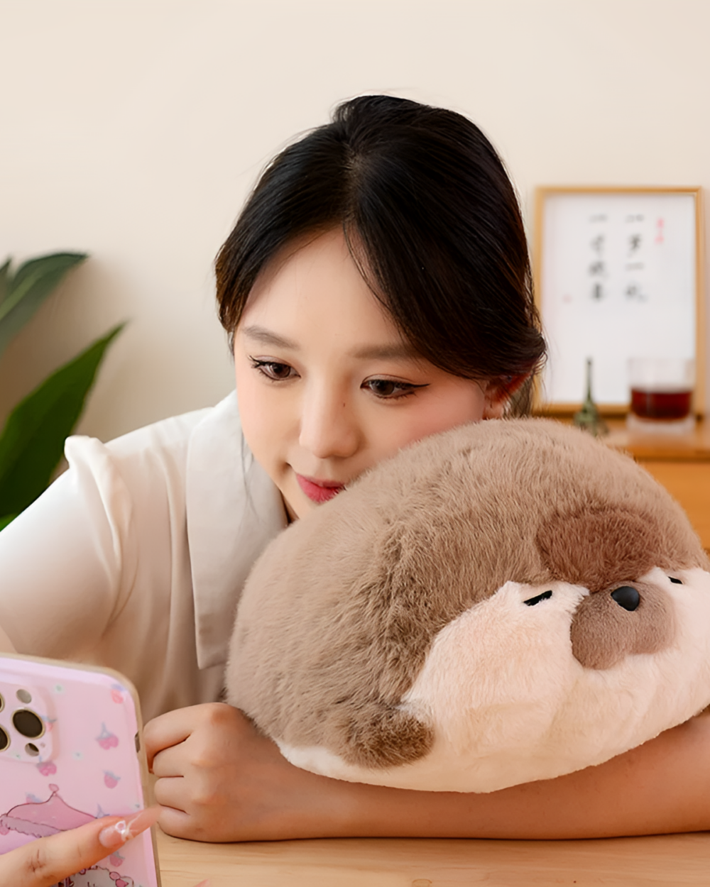 A brown Kawaii Seal Plushie rests in a woman’s arms, showcasing its soft texture.
