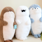 Three Kawaii Seal Plushies in brown, white, and blue colors stand side-by-side.