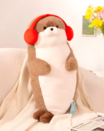 A brown Kawaii Seal Plushie wearing red earmuffs and sitting on a sofa with a newspaper.