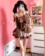 Woman wearing a Sweet Lolita Set, brown layered dress with lace details, pink room background.