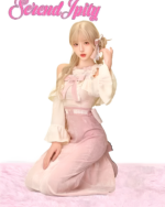Model wearing the Sweet and Fancy Set - Dollette Aesthetic Clothing, featuring a pink and cream outfit with lace details.