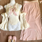 Dollette Aesthetic Clothing set featuring a lace top, dress, skirt, and shoes on a wooden surface.