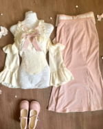 Dollette Aesthetic Clothing set featuring a lace top, dress, skirt, and shoes on a wooden surface.