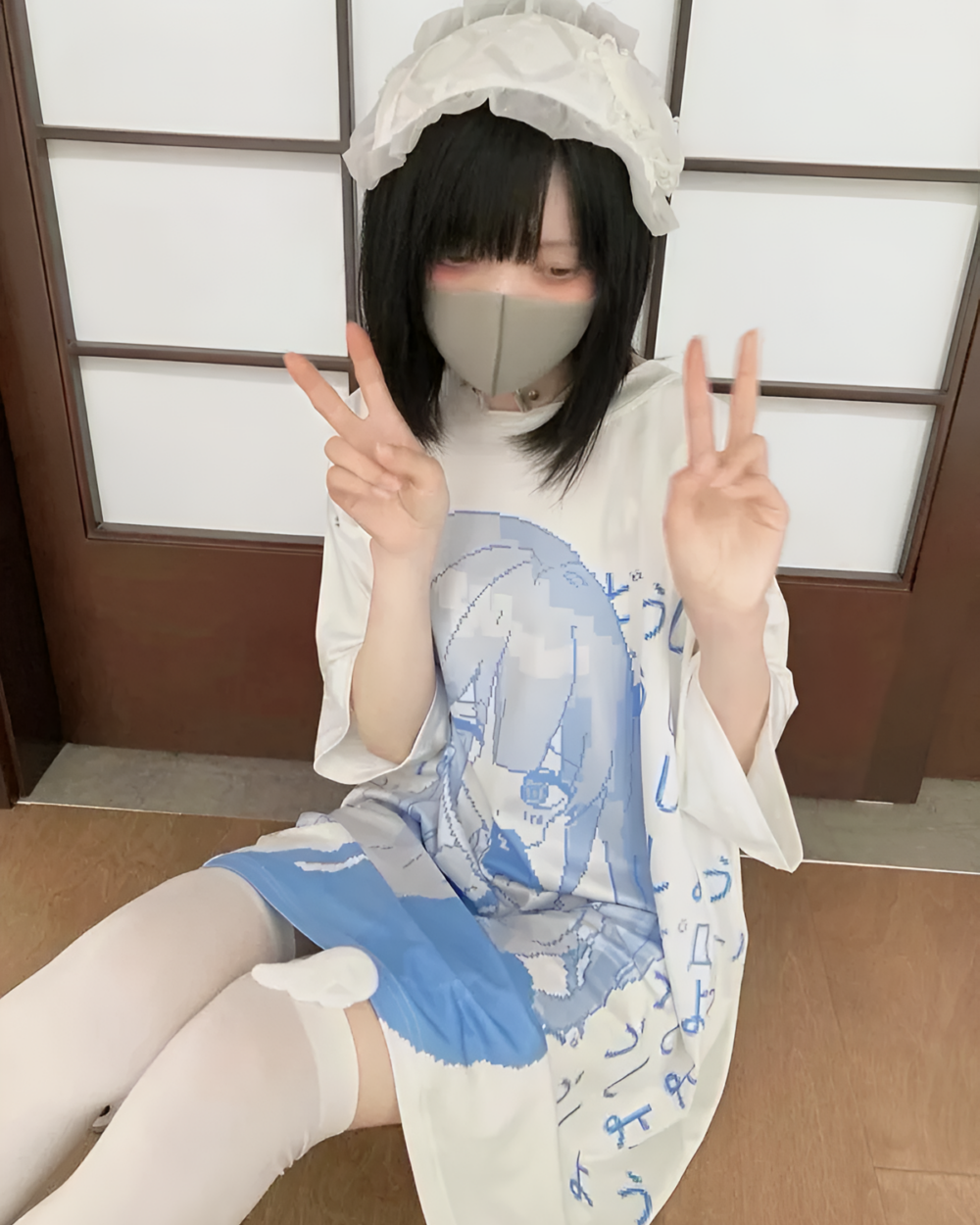 Model wearing a White Loose T-Shirt - Animecore Aesthetic. Blue graphic print, headband, and mask.